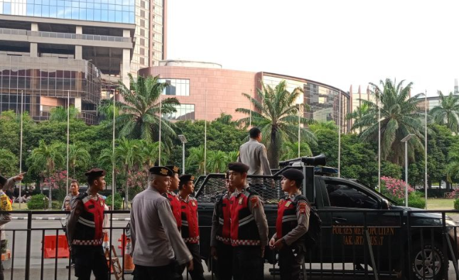 Polisi berjaga di pintu masuk kedatangan massa pasangan calon gubernur dan wakil gubernur Pilkada Jakarta 2024 di Jakarta International Expo (JIExpo), Kemayoran, Jakarta Pusat, Minggu (6/10/2024) malam. ANTARA/Siti Nurhaliza